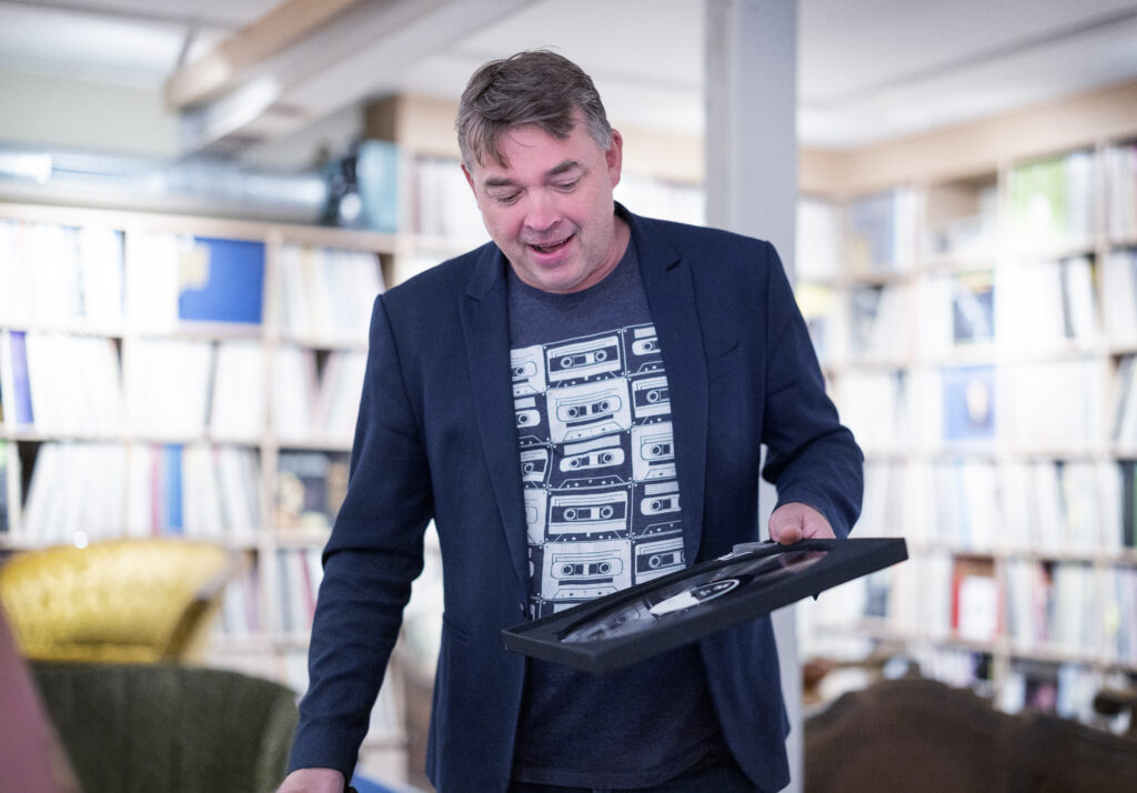 Daglig leder Per Arne Alstad i Tou scene viser fram en LP-plate produsert ved hjelp av kjøleenergi fra kaldt fjordvann.
